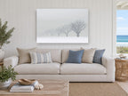 Fading Winter Orchard landscape canvas print on the wall of a beach house living room