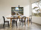 Sunlit Lane Through Pines landscape canvas print on the wall of a dining room