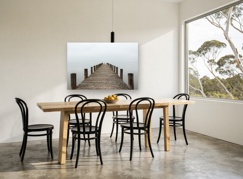 Jetty Into the Mist coastal canvas print on the wall of a dining room