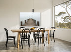 Jetty Into the Mist coastal canvas print on the wall of a dining room