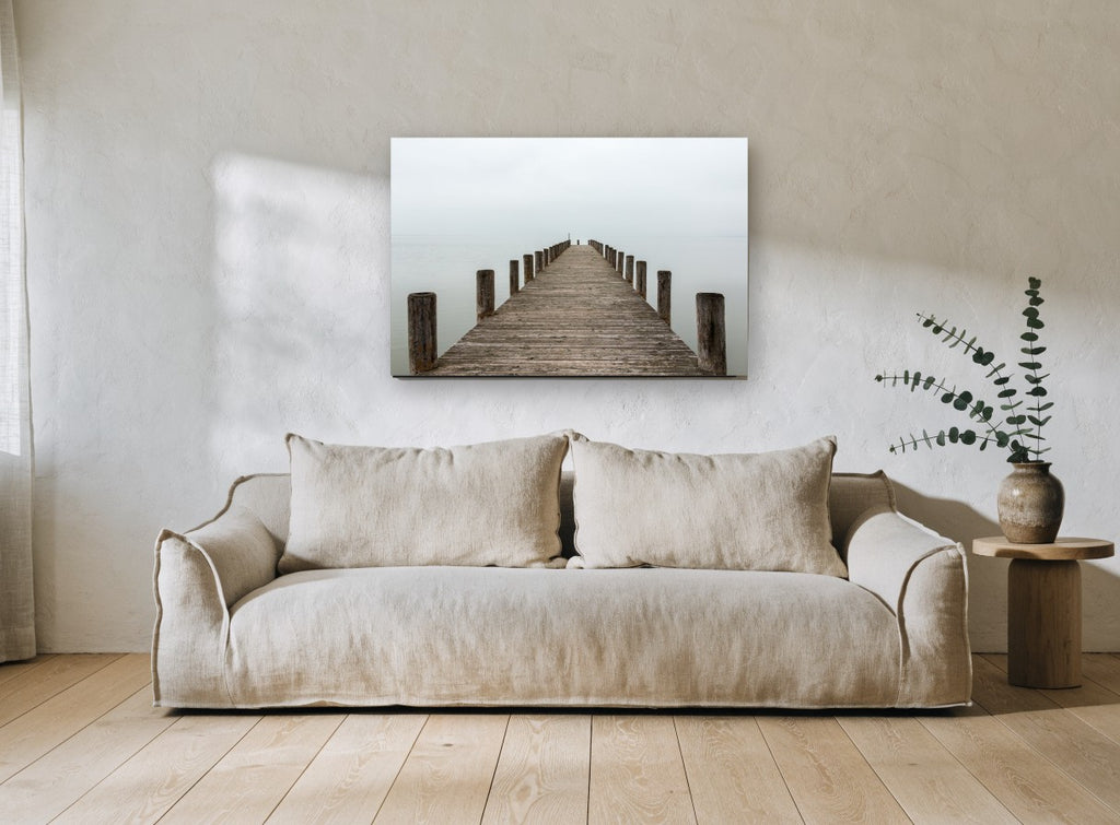 Jetty Into the Mist coastal canvas print on the wall of a living room