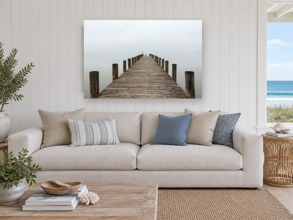 Jetty Into the Mist coastal canvas print on the wall of a beach house living room