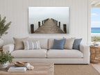 Jetty Into the Mist coastal canvas print on the wall of a beach house living room