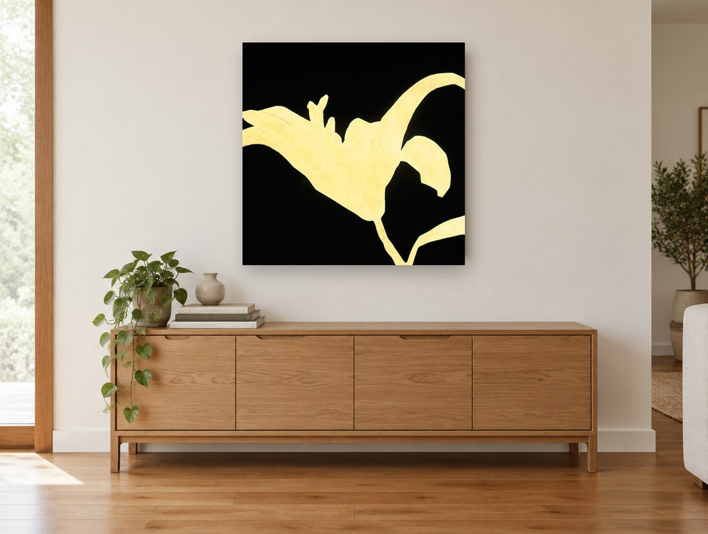 Golden Lily Silhouette floral canvas print on the wall of a living room above a sideboard
