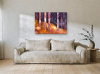 Backlit Amber Trunks landscape canvas print on the wall of a living room