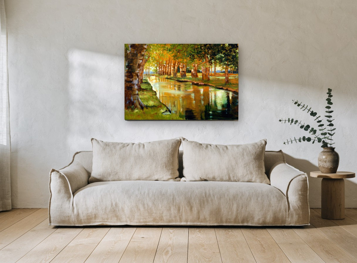Sunlit Plane Tree Canal landscape canvas print on the wall of a living room