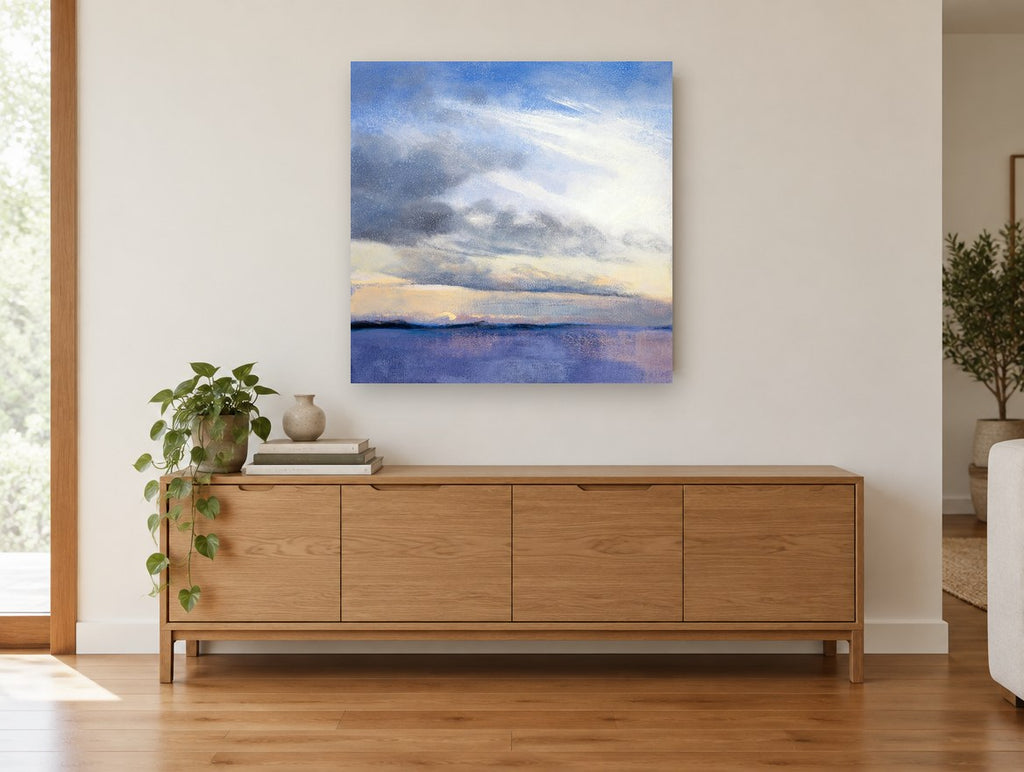 Dawn Over Violet Water coastal canvas print on the wall of a living room above a sideboard