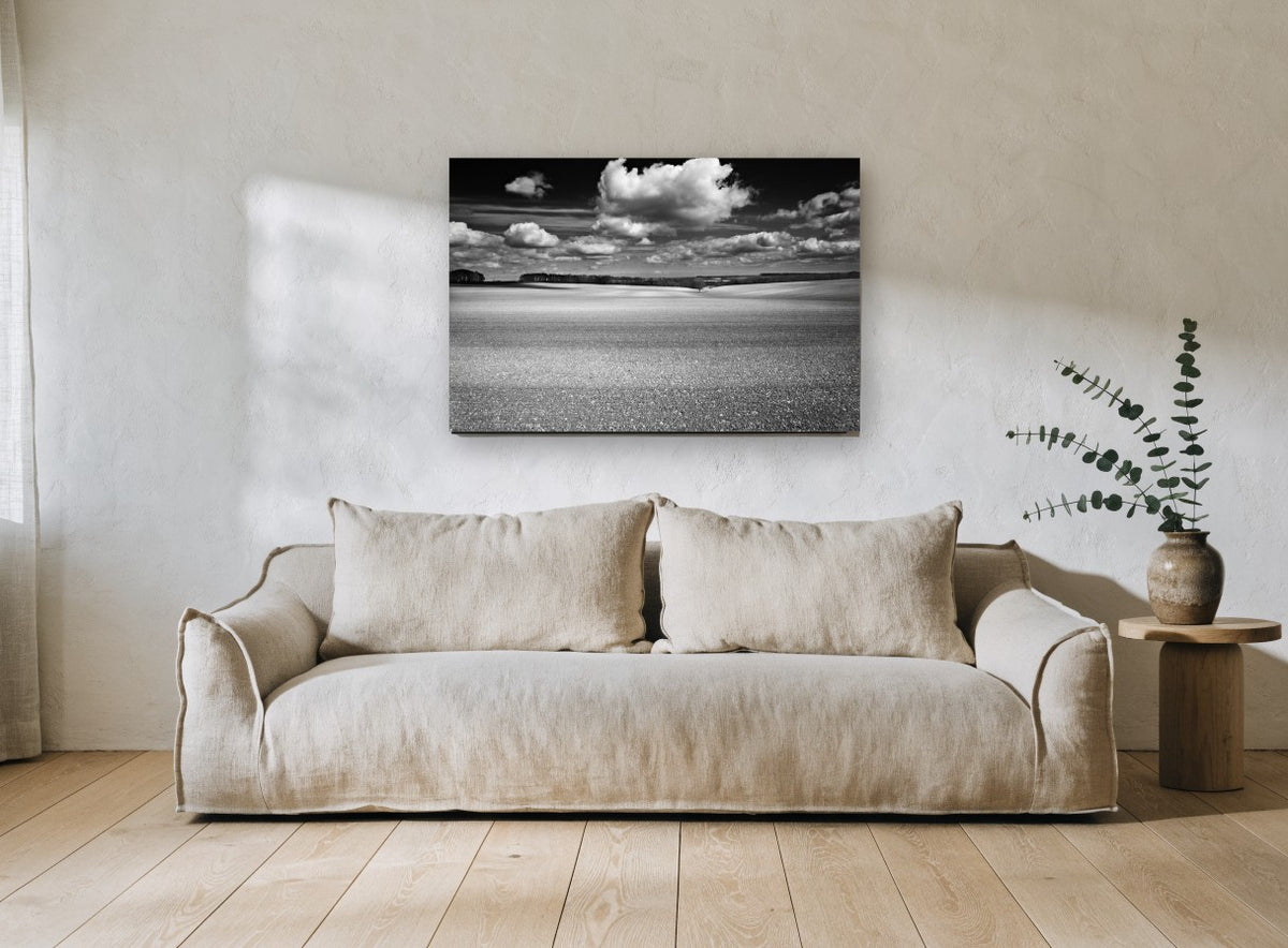 Ploughed Field Clouds landscape canvas print on the wall of a living room