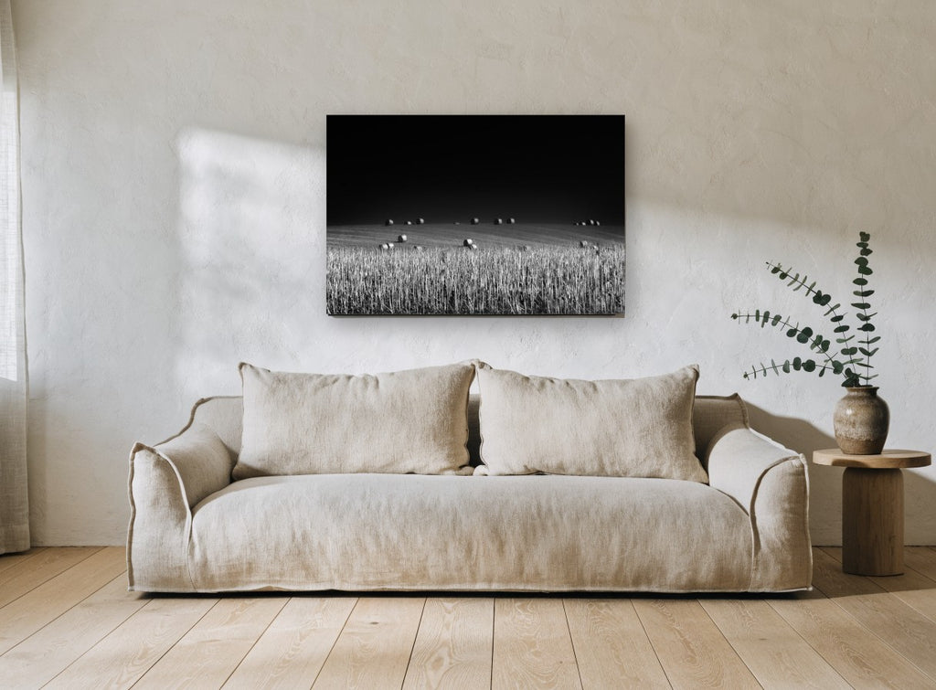 Bales Under Dark Sky landscape canvas print on the wall of a living room