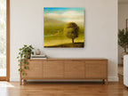 Lone Tree Green Valley landscape canvas print on the wall of a living room above a sideboard
