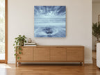 Stone in the Swirl coastal canvas print on the wall of a living room above a sideboard