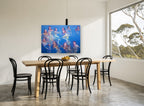 Swimmers in Blue Water coastal canvas print on the wall of a dining room