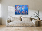 Swimmers in Blue Water coastal canvas print on the wall of a living room