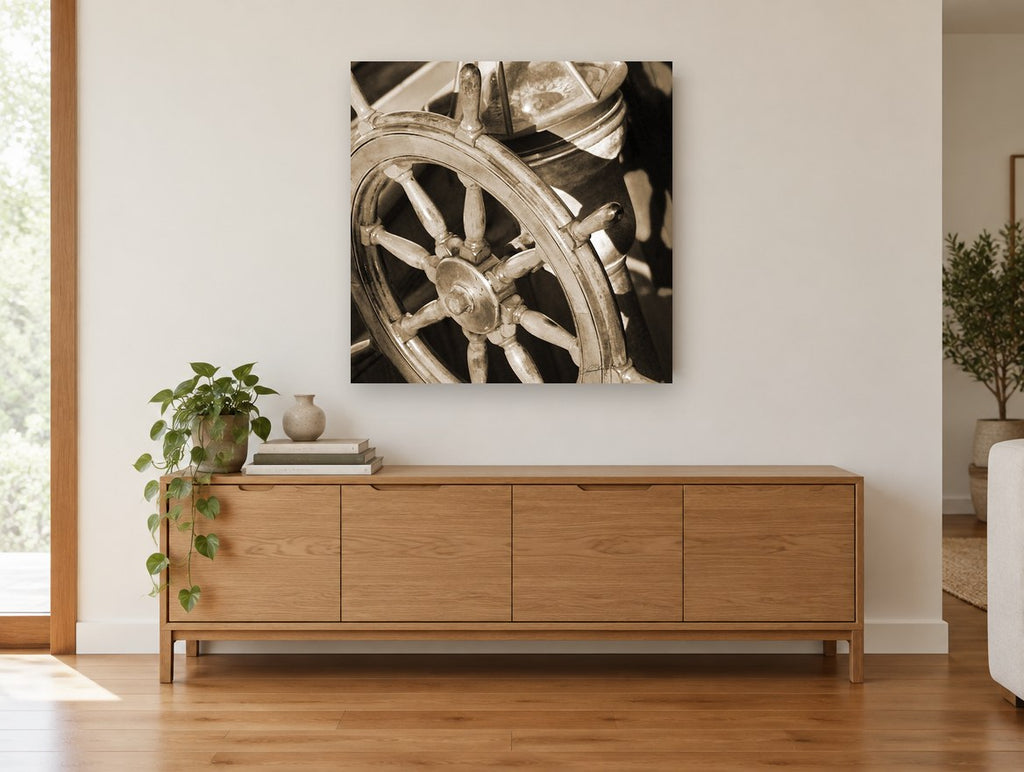 Sepia Helm Wheel coastal canvas print on the wall of a living room above a sideboard
