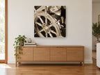 Sepia Helm Wheel coastal canvas print on the wall of a living room above a sideboard