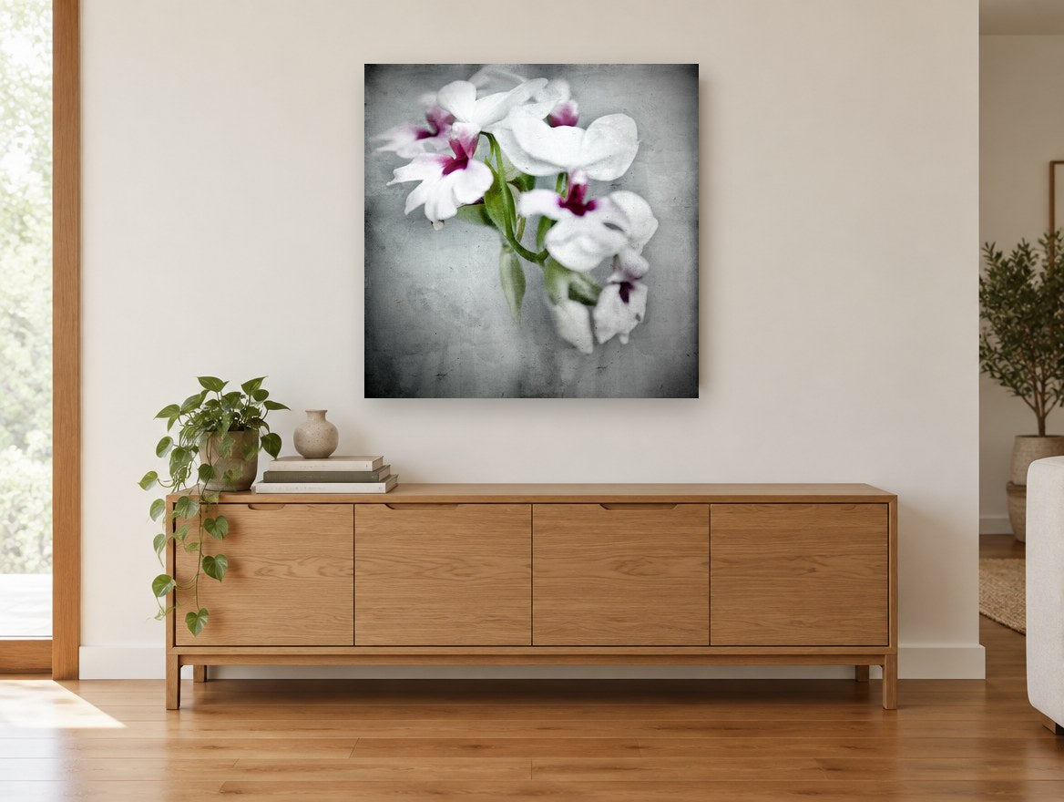 Soft Orchid Spray floral canvas print on the wall of a living room above a sideboard