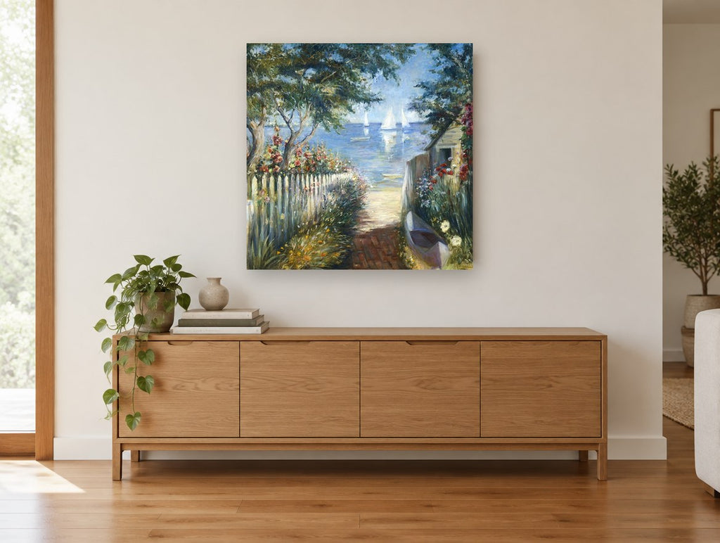 Garden Path to the Bay coastal canvas print on the wall of a living room above a sideboard