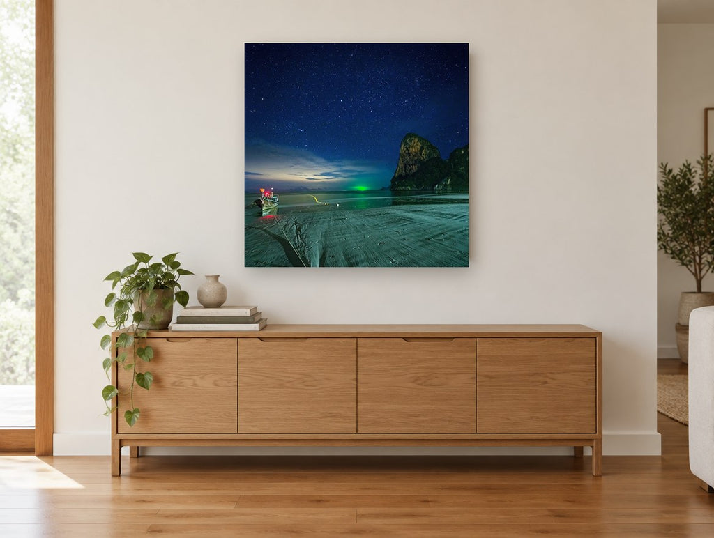 Starlit Longtail Bay coastal canvas print on the wall of a living room above a sideboard