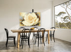 Cream Rose Bloom floral canvas print on the wall of a dining room