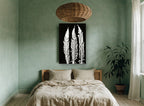 Three White Fern Fronds floral canvas print on the wall of a bedroom