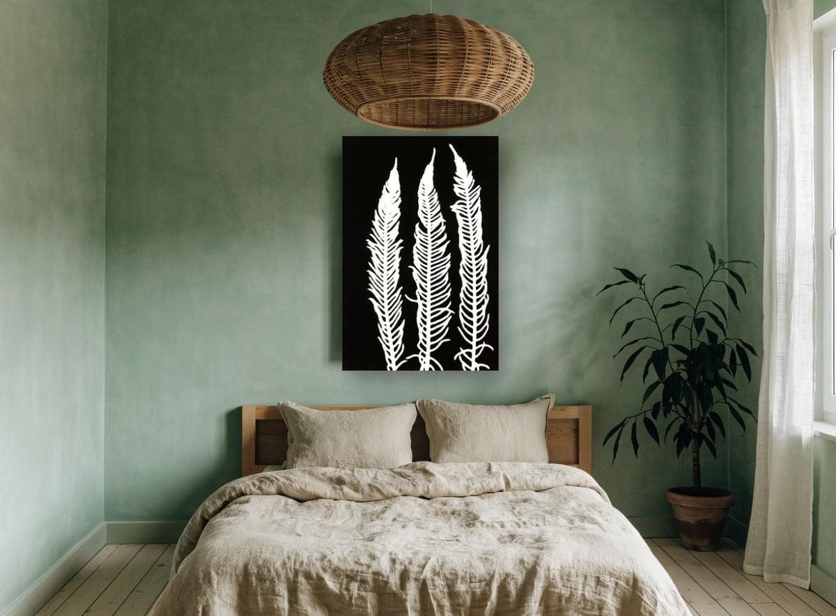 Three White Fern Fronds floral canvas print on the wall of a bedroom