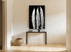 Three White Fern Fronds floral canvas print on the wall of a hallway