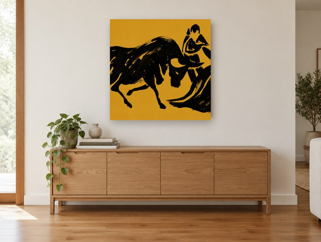 Ochre Bull and Matador animal canvas print on the wall of a living room above a sideboard