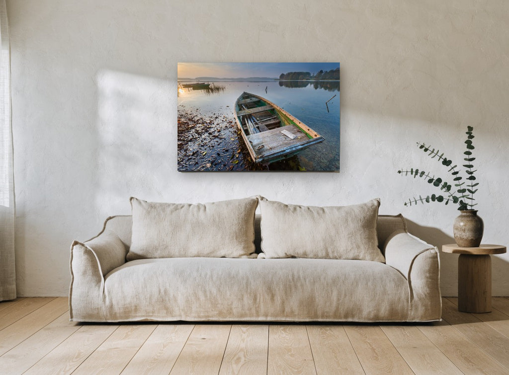Weathered Rowboat Dawn landscape canvas print on the wall of a living room