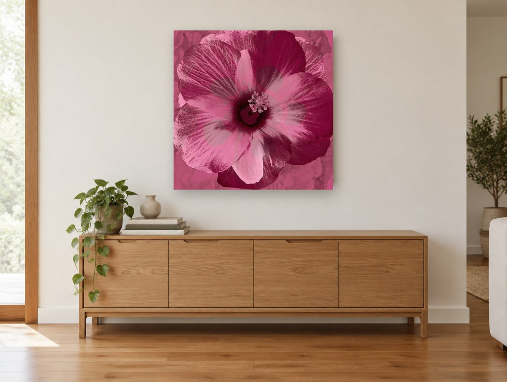 Magenta Hibiscus Bloom floral canvas print on the wall of a living room above a sideboard