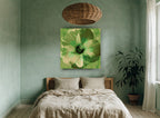 Green Hibiscus Bloom floral canvas print on the wall of a bedroom