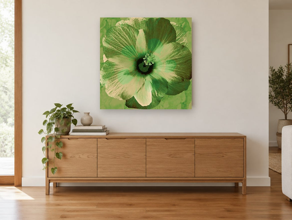 Green Hibiscus Bloom floral canvas print on the wall of a living room above a sideboard