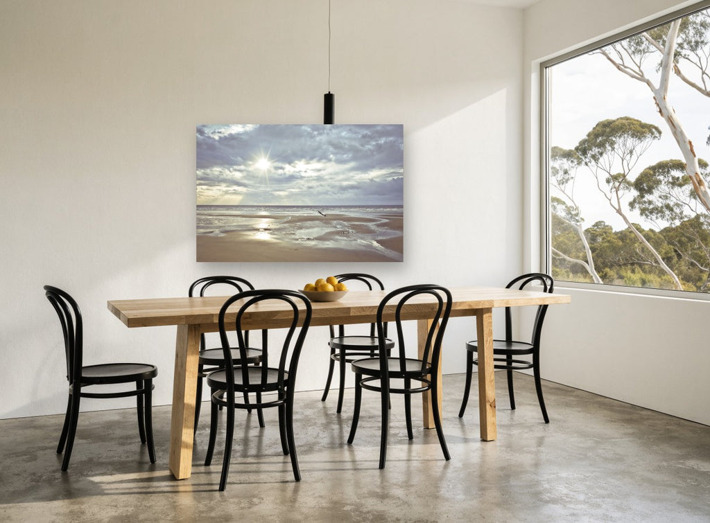 Low Tide Sunburst coastal canvas print on the wall of a dining room