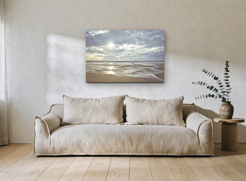 Low Tide Sunburst coastal canvas print on the wall of a living room
