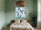 Plum Hibiscus on Aqua floral canvas print on the wall of a bedroom