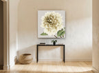 Cream Dahlia Bloom floral canvas print on the wall of a hallway