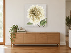 Cream Dahlia Bloom floral canvas print on the wall of a living room above a sideboard
