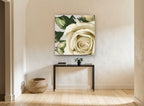Cream Rose Unfurling floral canvas print on the wall of a hallway