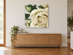Cream Rose Unfurling floral canvas print on the wall of a living room above a sideboard