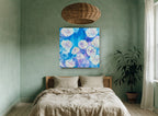 Blue Rose Burst floral canvas print on the wall of a bedroom