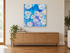 Blue Rose Burst floral canvas print on the wall of a living room above a sideboard