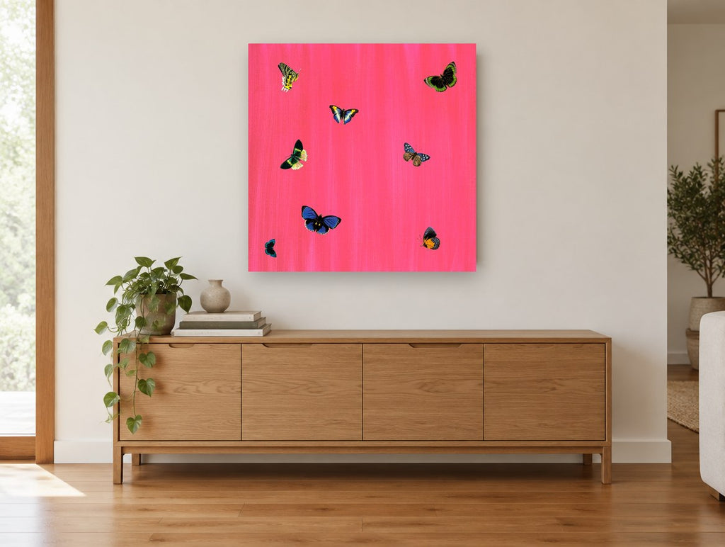 Butterflies on Hot Pink animal canvas print on the wall of a living room above a sideboard