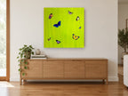 Butterflies on Lime animal canvas print on the wall of a living room above a sideboard