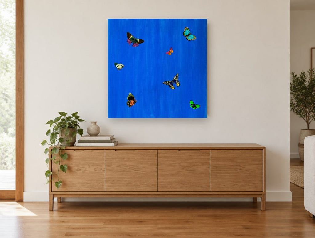 Butterflies on Cobalt animal canvas print on the wall of a living room above a sideboard