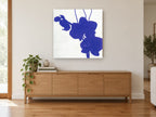 Indigo Orchid Silhouette floral canvas print on the wall of a living room above a sideboard