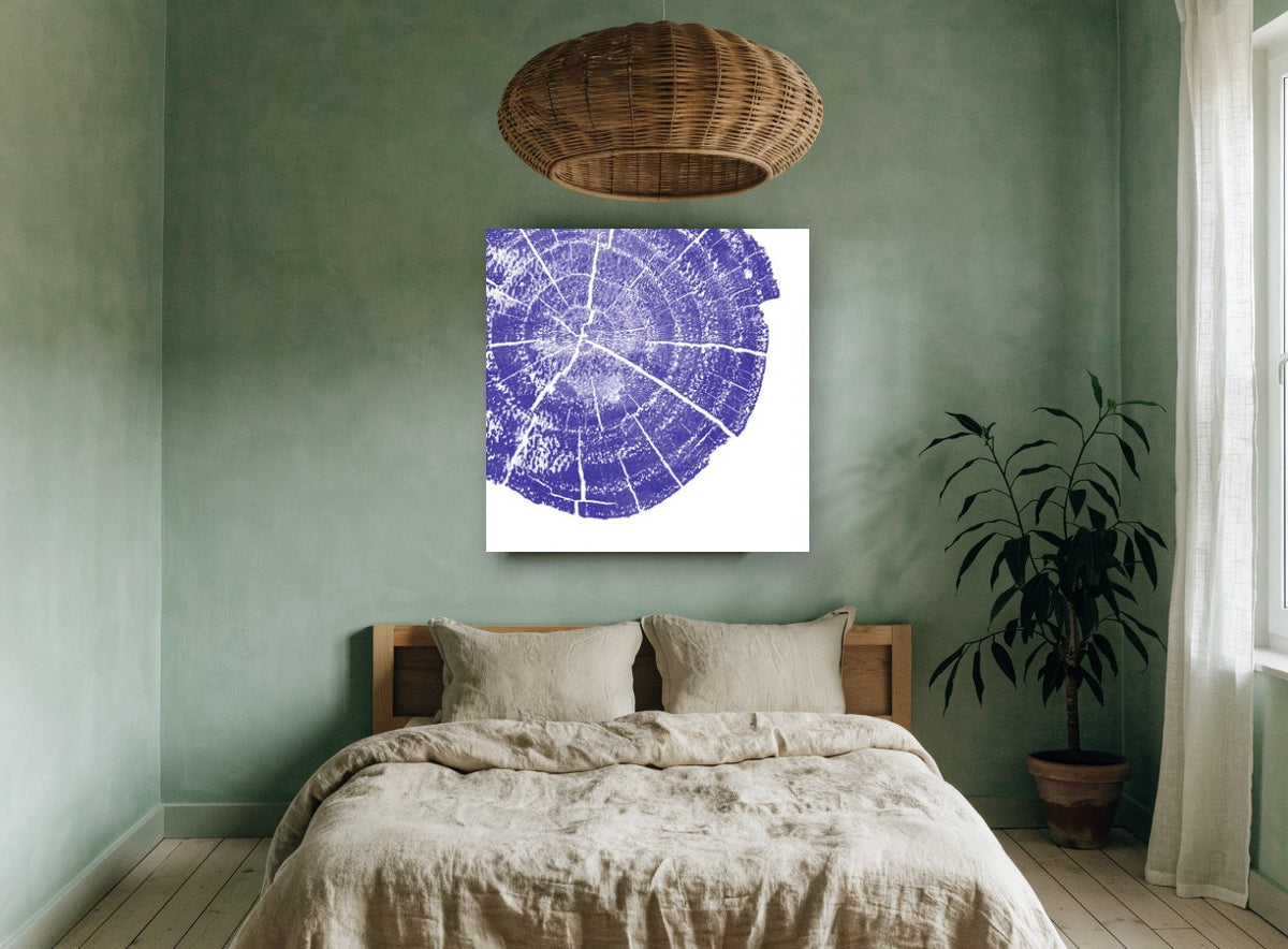 Indigo Tree Rings floral canvas print on the wall of a bedroom