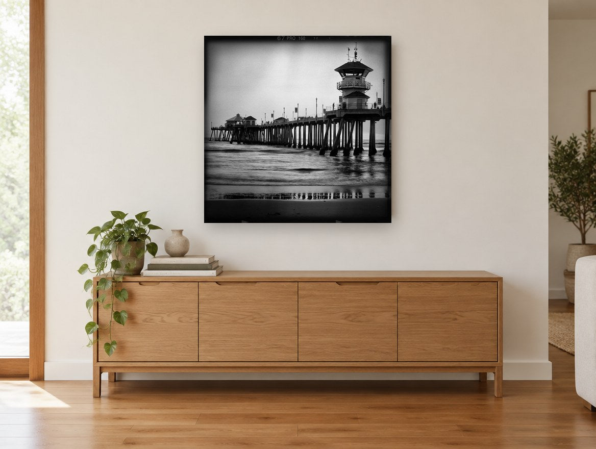 Pier Tower at Dusk coastal canvas print on the wall of a living room above a sideboard