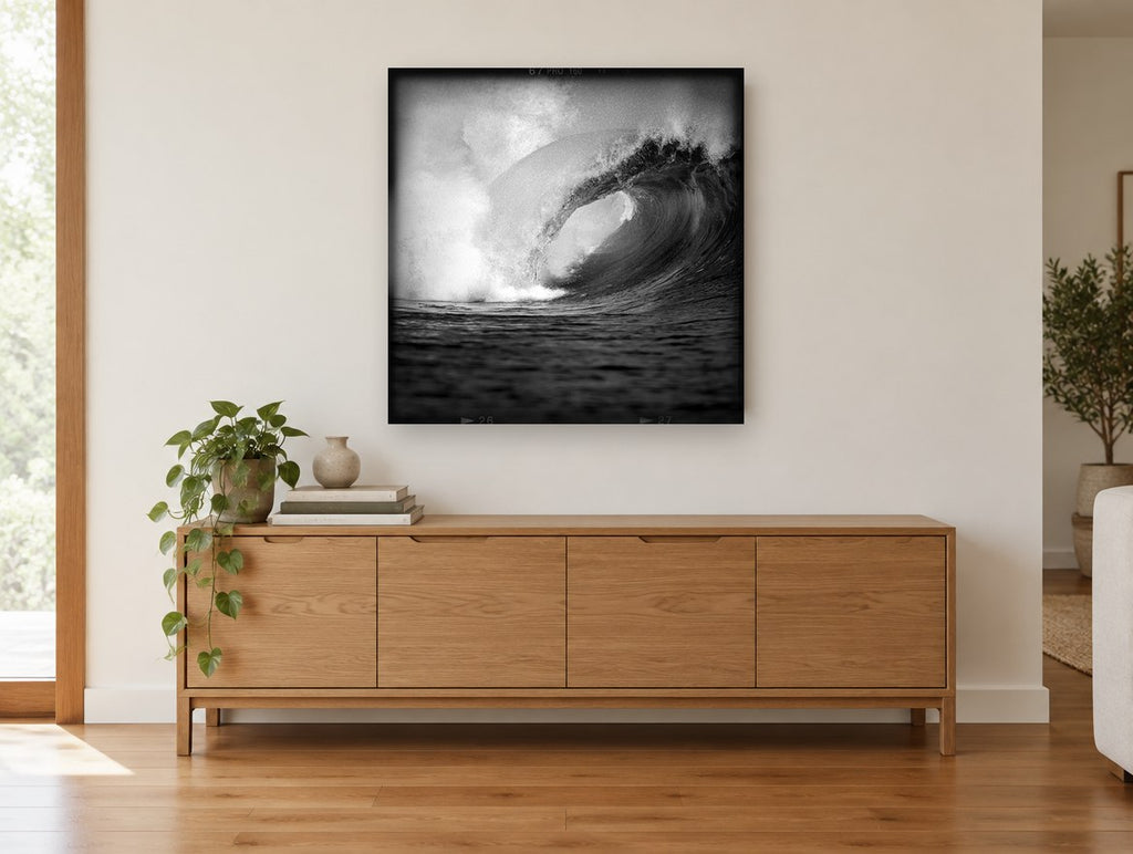 Hollow Barrel Wave coastal canvas print on the wall of a living room above a sideboard