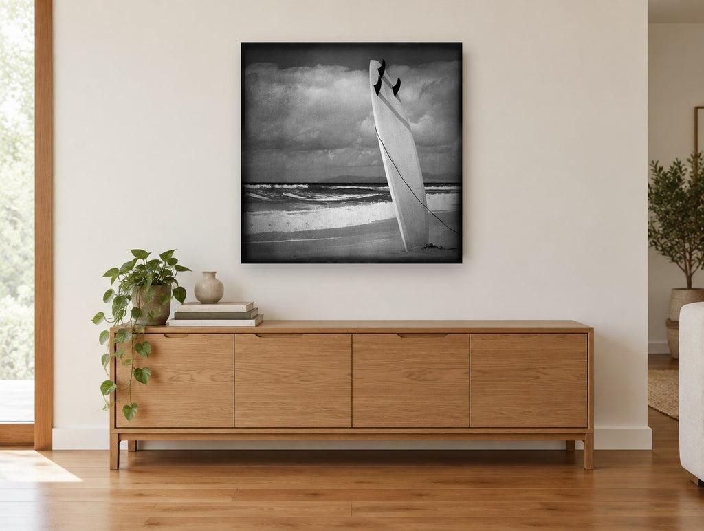 Standing Surfboard Dusk coastal canvas print on the wall of a living room above a sideboard