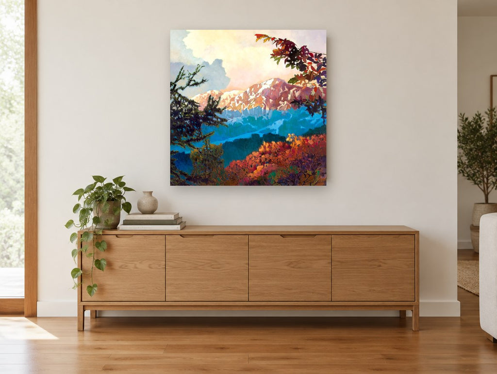 Alpenglow Through Branches landscape canvas print on the wall of a living room above a sideboard