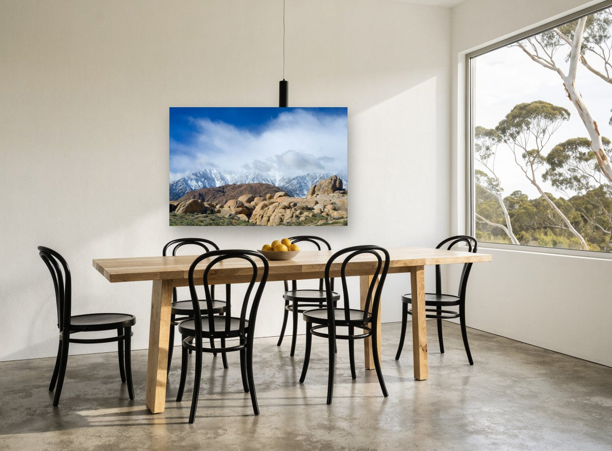 Boulders Beneath Snow Peaks landscape canvas print on the wall of a dining room